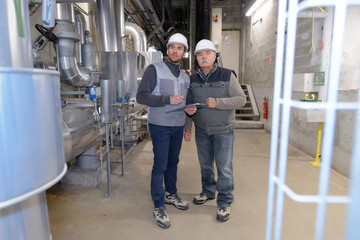 two engineers in the boiler room