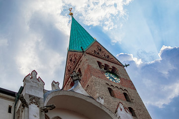 Spectacular view of one of the towers of the Augsburg Cathedral with the cloudy sky. Photography...