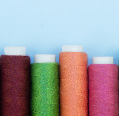 Multi-colored threads in spools, sewing kit. Close-up