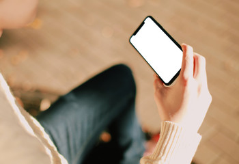 man holding mobile phone with blank screen