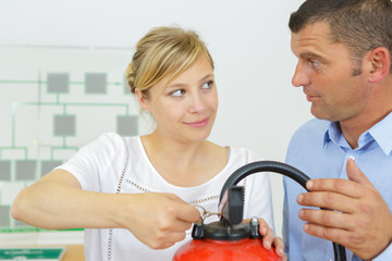 couple in store holding fire extinguisher