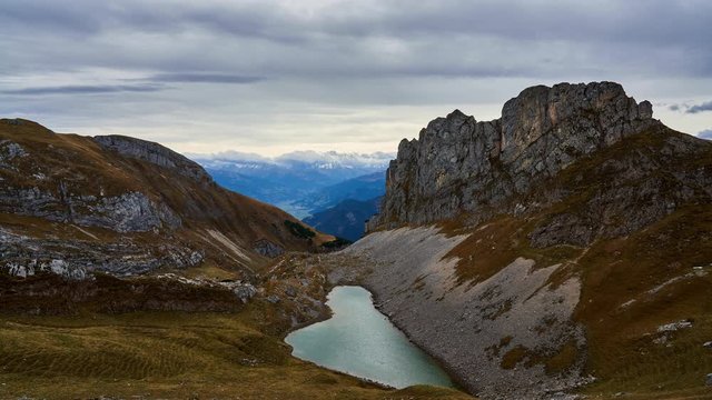 Time Lapse of high mountains and alpine lake (Grubersee) from Rofanspitze in the Austrian alps