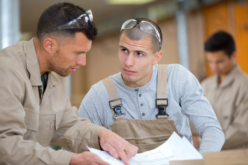 two men in carpentry workshop
