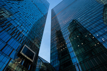Fototapeta na wymiar Modern business center in Moscow city. Modern urban architecture, glass skyscraper on a clear evening, view from below.