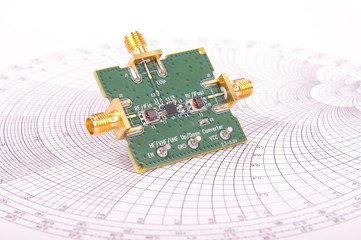 Radio frequency mixer PCB in front of Smith chart - obrazy, fototapety, plakaty