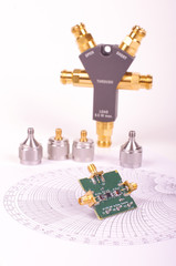 RF mixer electronics PCB in front of Smith chart and other microwave measurement tools and symbols - obrazy, fototapety, plakaty