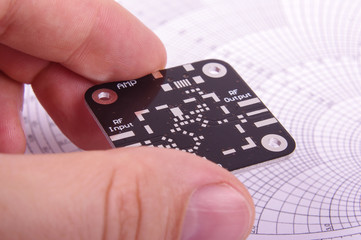 RF engineer holding empty black PCB board - obrazy, fototapety, plakaty