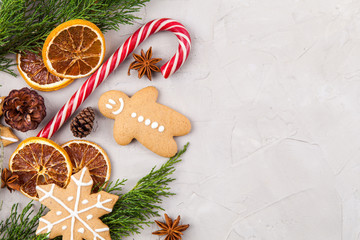 christmas homemade gingerbread cookies, spices and cutting board on dark green background with copy space for text