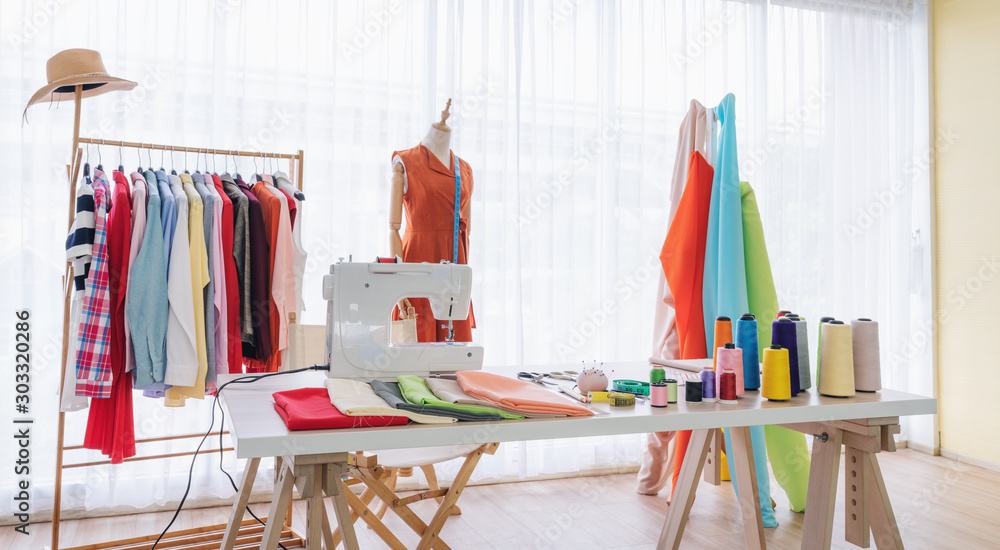 Wall mural Fashion designer working studio, with sewing items and materials on working table