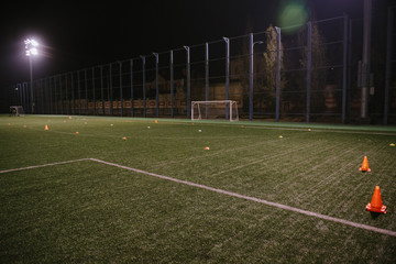 Orange cones for training football on the field
