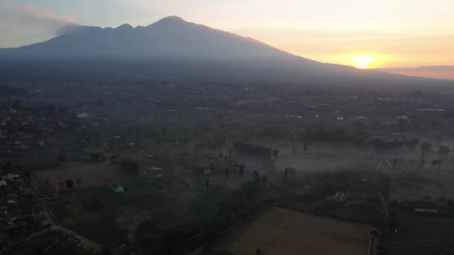 Misty morning drone footage of Arjuno Wlirang, a stratovolcano residing in Batu City in East Java, Indonesia.