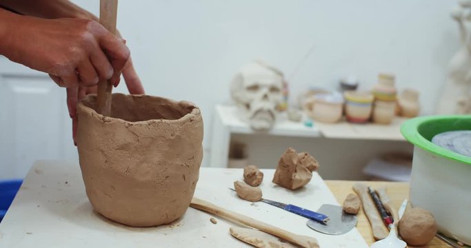 Handmade business online. Art education courses. Female sculptor artist teaching children. Closeup of woman hands modeling cley pot. Performance inspiration. Enjoying creative process.