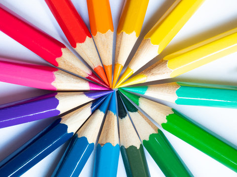 Many different colored pencils on white background, Colored pencils in arrange in color wheel colors on white background, Group of multicolor pencils.