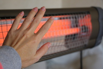 Infrared heater in the house. Warm light. Incandescent lamp.