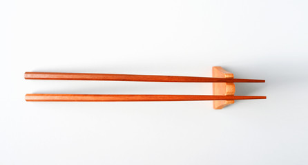 Wooden chopsticks on a white table top view