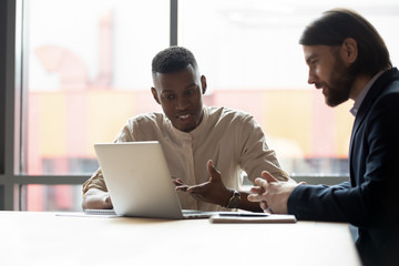 African american specialist explaining new company software to manager.