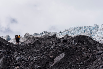 Rear view mountaineer reaching Michinmahuida glacier in Pumalin Park, Chaiten, Patagonia, Chile