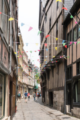 tourists visit the historic old city center of Rouen in Normandy with hits famous half-timbered houses