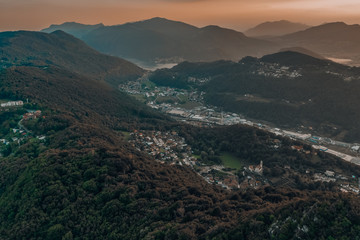 Aerial drone shot sunset view of Monte Salvatore, Swiss village Carabbia, Carabietta, agara Ti, Grancia Barbengo