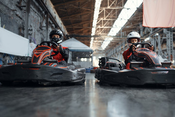 Two kart racers fight for victory, side view
