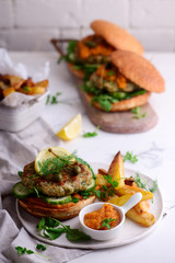 Fish burger with herb and corgette sauce.