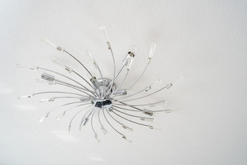 Chromed ceiling chandelier in the form of many swirling beams
