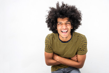 cool young handsome North African man with afro hair laughing with arms crossed