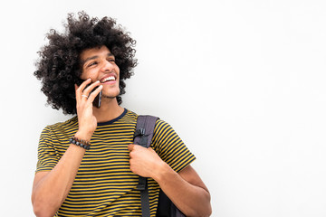 happy young guy with bag and talking with cellphone on isolated white background