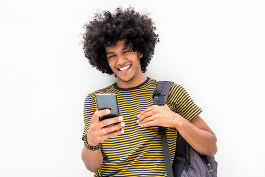 Cool Young Guy With Bag Looking At Cellphone And Smiling