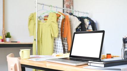 Workspace of designer studio laptop computer empty screen on creativity desk.