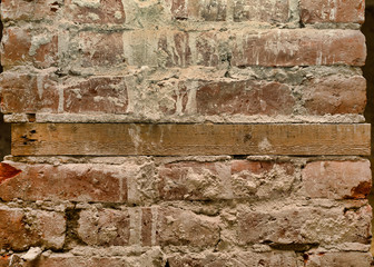 Old brick wall with wooden mortgage.
