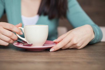 female hands holding with cup of coffee