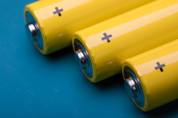 Yellow alkaline batteries on blue background