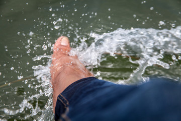 leg in the river from a running boat
