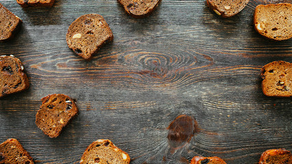 Bakery food. Homemade bread slices. Brown rustic wooden background.