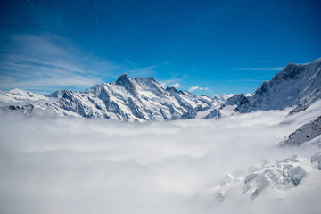 Charming scene of snow mountain above cloud with clear blue sky, Jungfrau, Switzerland, for background, copy space