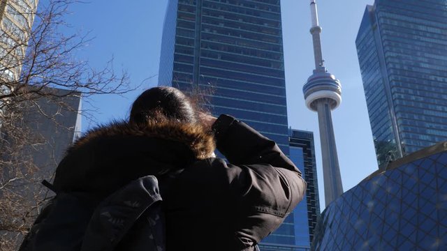 Photographer downtown Toronto taking photo of CN Tower 3