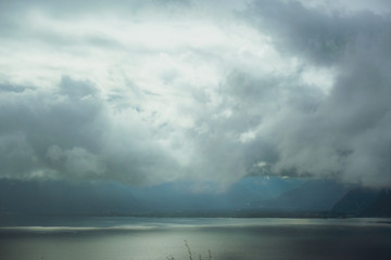 Naklejka na ściany i meble Lake Geneva (CH) through the clouds - from the highway