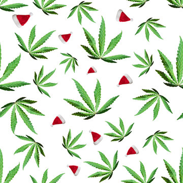 Green cannabis leaves and Santa Claus caps isolated on white background. Seamless texture. Top view, image Wallpaper close-up