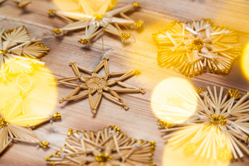 Christmas straw stars on wooden background