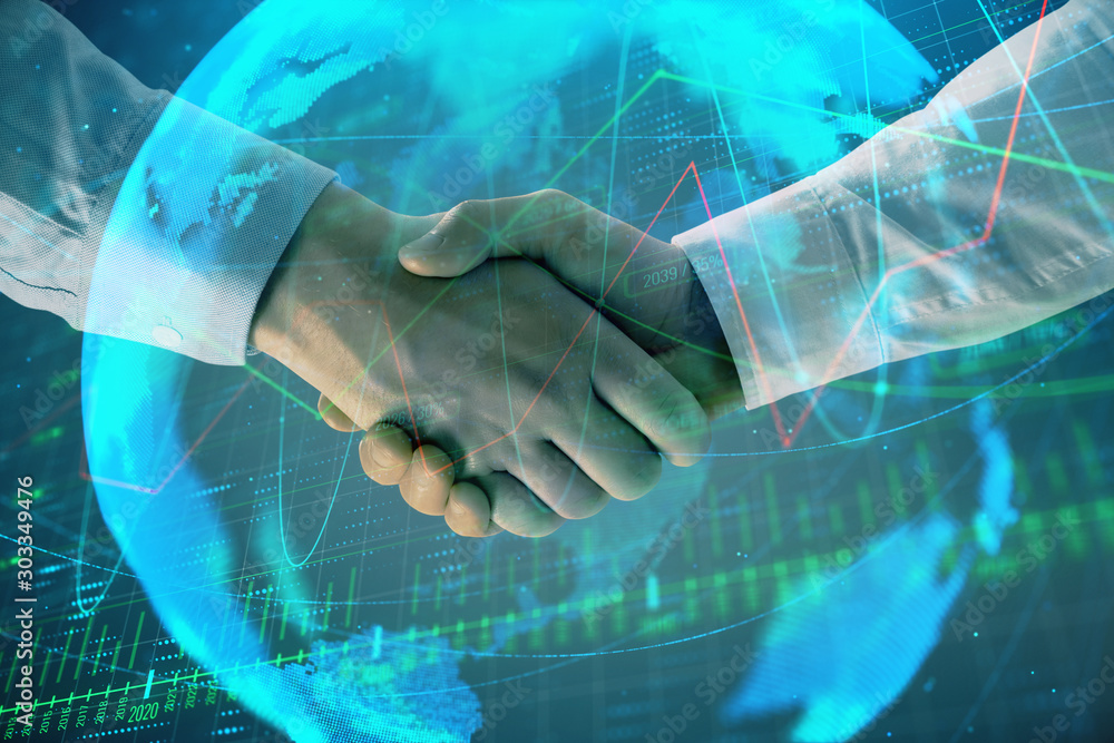 Poster multi exposure of forex graph and world map on abstract background with two businessmen handshake. c