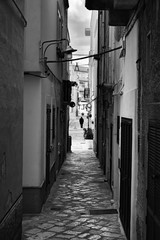Fototapeta premium Evening winter on the streets of Polignano a Mare Old Town, Bari Province, Puglia region, southern Italy. Black and white image.