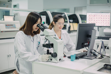 Medical doctor or health care professional working for analyzing blood samples in laboratory of scientific research. Concept for biology chemistry HIV hematology and medical equipments safety lab.