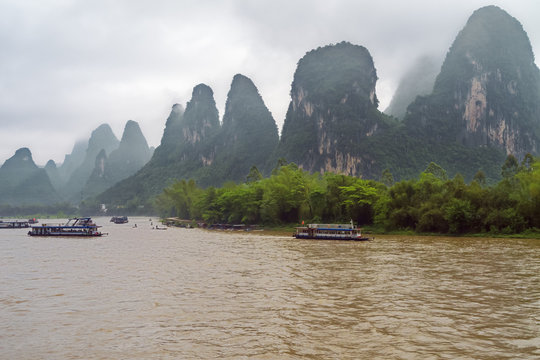 Busy traffic on the Li River near Xingpingzhen fishing village in the vicinity of Yangshuo near Guilin