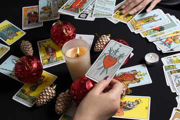 Bangkok,Thailand,november.17.19. Gypsy lays out Tarot cards and wonders for the future. Christmas fortune telling and fortune telling. Magical sessions with the cards. Women's hands and Tarot cards.