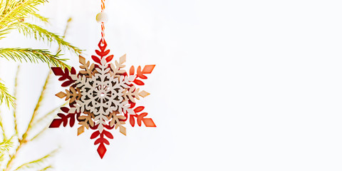 Holiday border with hanging christmas tree bauble decorations on a light background