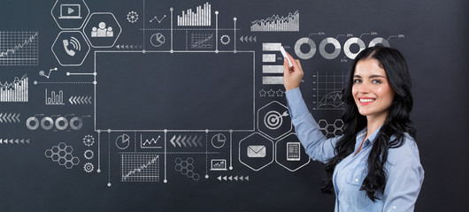 Marketing concept with young woman writing on a blackboard