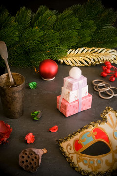Christmas Eve. Fantasy, magical still life. Romantic date. Table, mask, gifts antiques, vintage, tree.