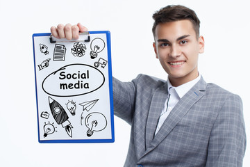 Business, technology, internet and network concept. Young businessman shows a keyword: Social media