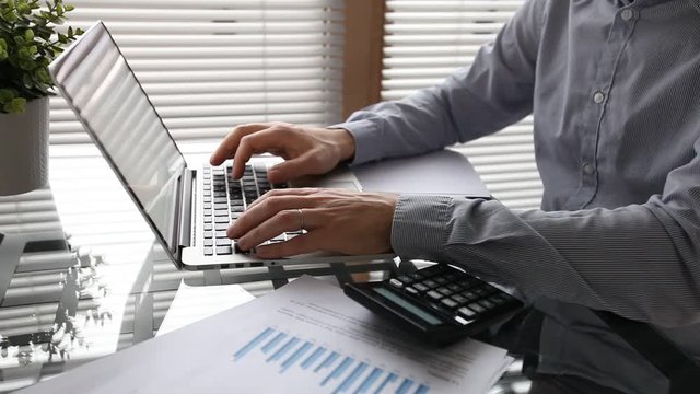 business plan, financial simulation, businessman working on laptop computer in office